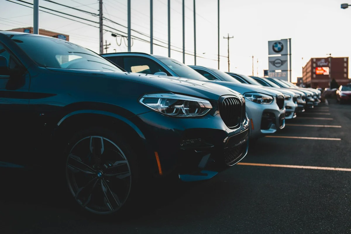 Row of new cars parked on a dealership lot